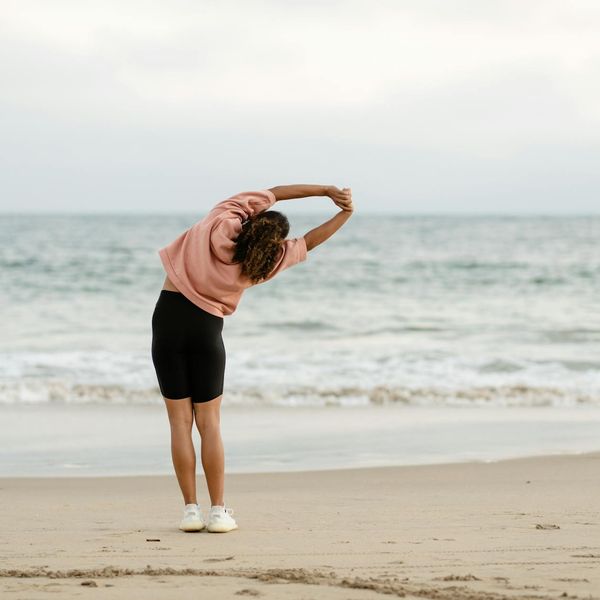 Man stretching outdoors feeling refreshed and energized.